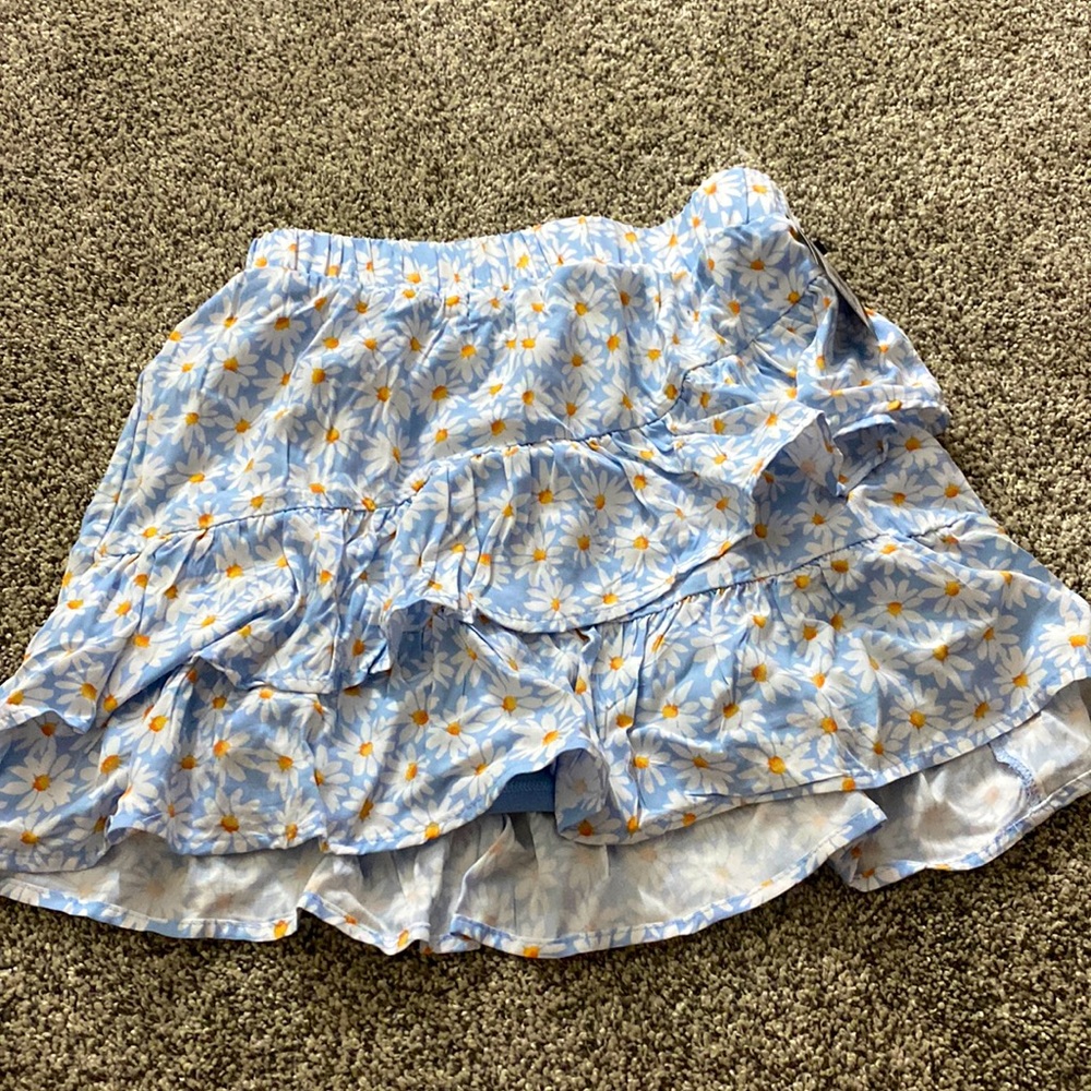 Blue girls skirt with daisys on it